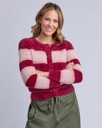 Behind The Trees - Woman wearing a pink and red striped sweater with green pants on a gray background - Elm - Anna Ombre Knit Cardigan - Maroon Ombre Stripe