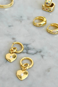 Behind The Trees - Gold hoop earrings with heart charms on a marble surface - Mosk.Melbourne - Gold Heart Drop Hoops