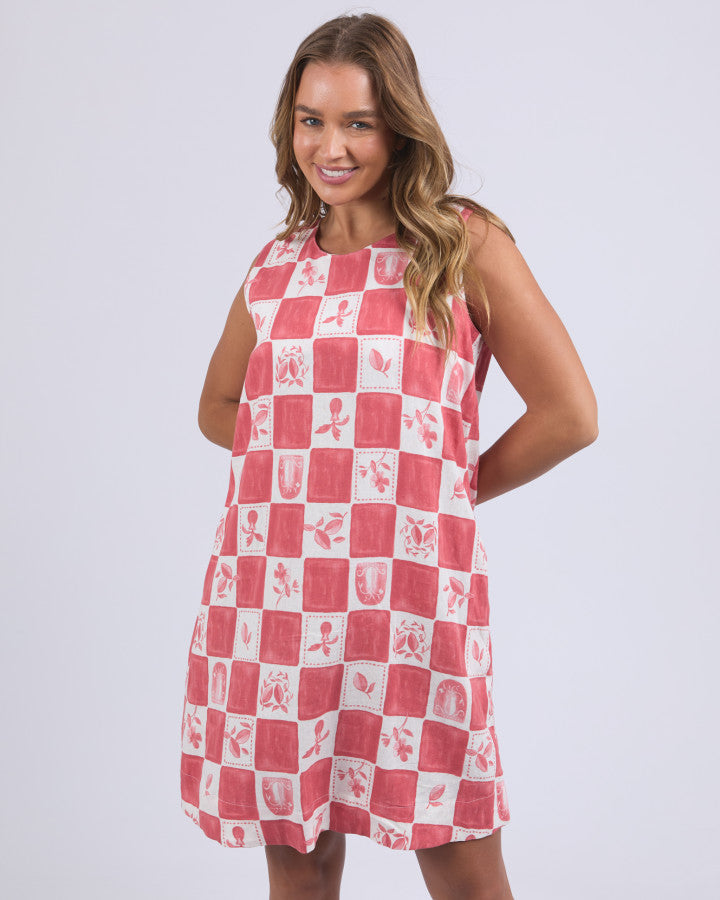 Behind The Trees - Woman wearing a red and white checkered dress on a plain background - Foxwood - Biarittz Dress - Crimson Print
