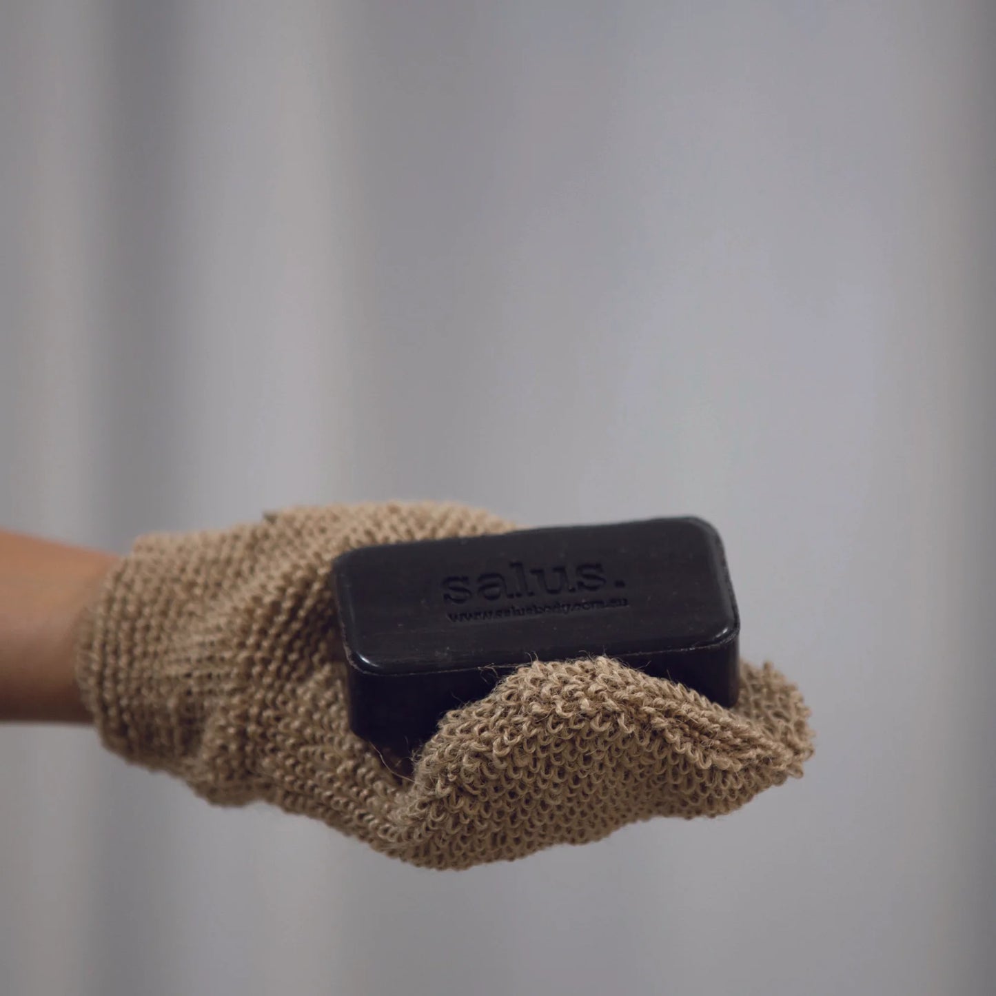 Behind The Trees - Body exfoliation mitt with 'salus' branding on a white background - Salus Body - Body Exfoliation Mitt