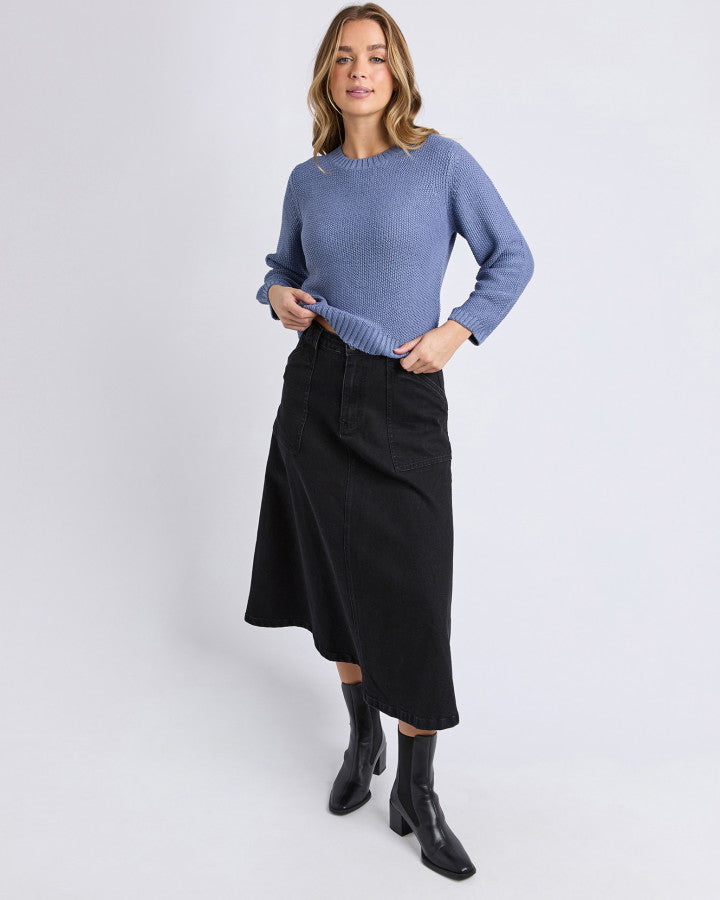 Behind The Trees - Woman wearing a blue knitted sweater against a plain background - Foxwood - Blair LS Knit - Country Blue