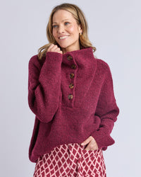 behind The Trees - Woman wearing a maroon knitted sweater with buttons on a light gray background - Elm - Bron Button Knit - Maroon
