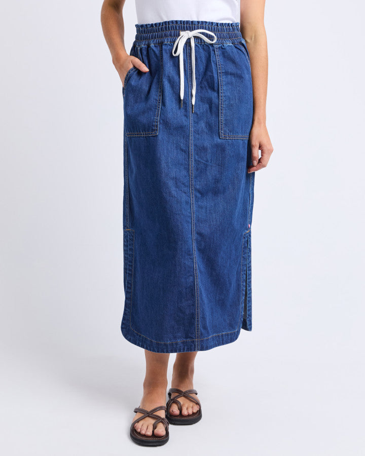 Behind The Trees - Woman wearing a white top and blue denim skirt on a white background - Elm - Clover Midi Denim Skirt - Mid Blue Wash