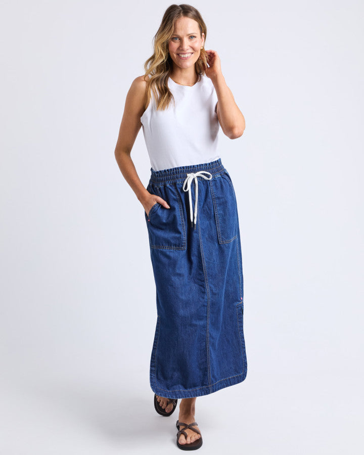 Behind The Trees - Woman wearing a white top and blue denim skirt on a white background - Elm - Clover Midi Denim Skirt - Mid Blue Wash