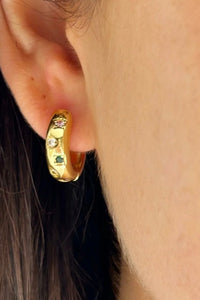 Behind The Trees - Gold hoop earring with embedded gemstones worn by a person. - Mosk.Melbourne - Cutie Earrings 