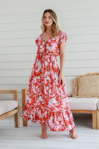 Behind The Trees - Woman wearing a red floral dress standing in a room with wooden furniture. - Miracle - Flutter Sleave Maxi Dress - Casia Print 