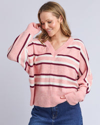 Behind The Trees - Woman wearing a pink and red striped sweater against a light gray background - Elm - Elsa Stripe Knit - Rose Stripe