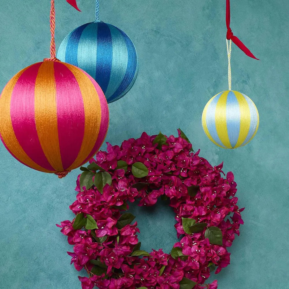 Behind The Trees - Yellow and blue striped paper lantern hanging against a light gray background - Florabelle Living - Silk Stripe Bauble Small  - Blue & Yellow - Christmas Decoration