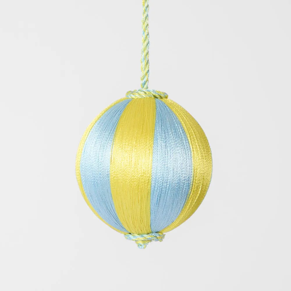 Behind The Trees - Yellow and blue striped paper lantern hanging against a light gray background - Florabelle Living - Silk Stripe Bauble Small  - Blue & Yellow - Christmas Decoration