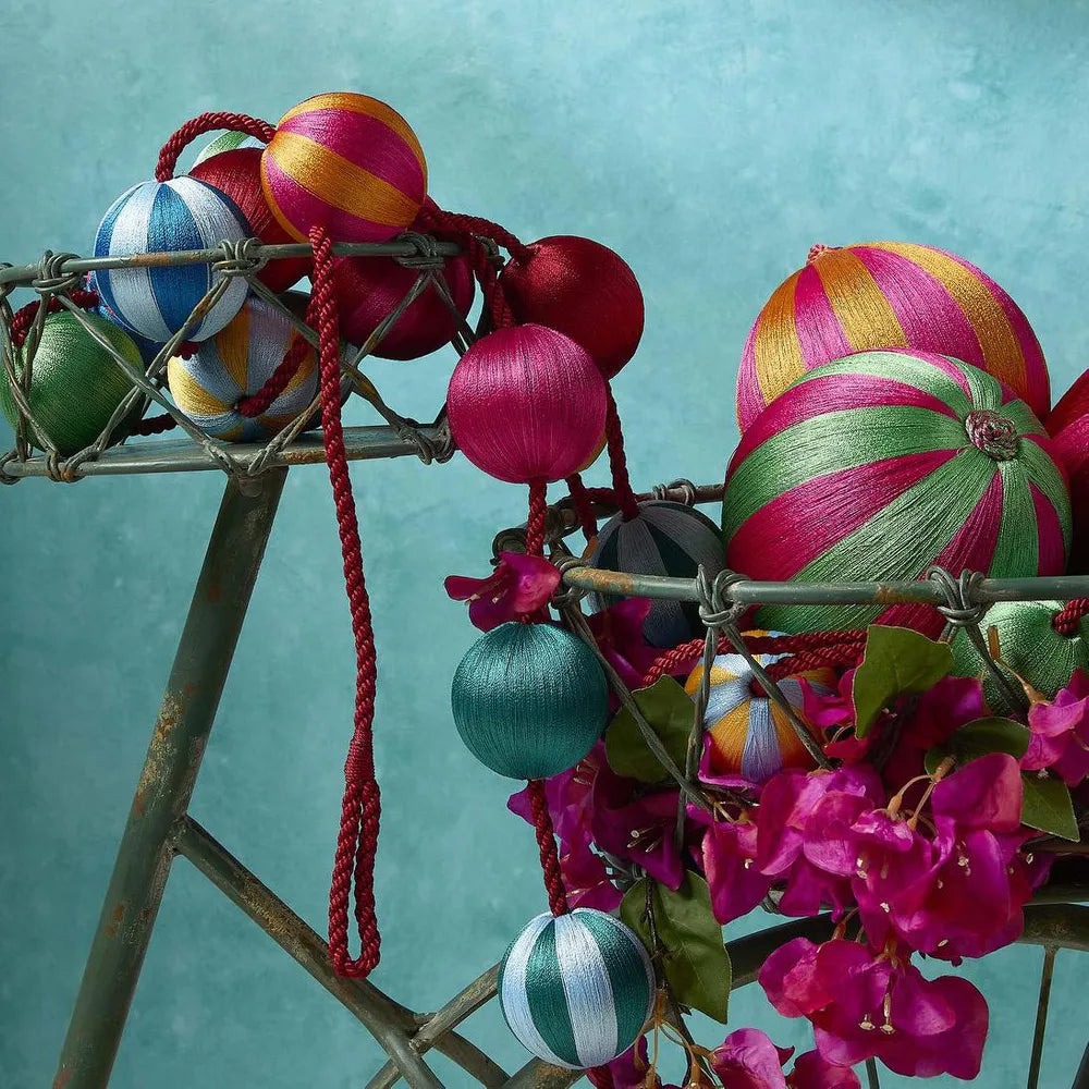 Behind The Trees - Blue and green striped ball hanging on a white background - Florabelle Living - Silk Stripe Bauble Small  - Blue & Turquoise - Christmas Decorations