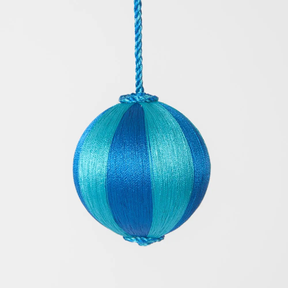 Behind The Trees - Blue and green striped ball hanging on a white background - Florabelle Living - Silk Stripe Bauble Small  - Blue & Turquoise - Christmas Decorations