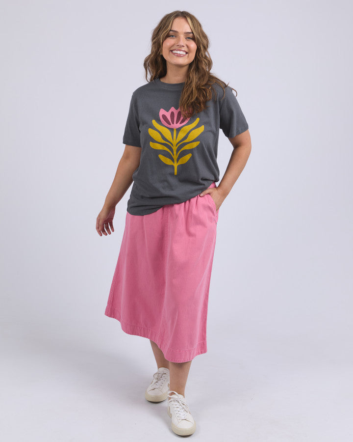 Behind The Trees - Woman wearing a gray t-shirt with a pink and yellow floral design on a plain background - Elm - Fiore Tee - Charcoal