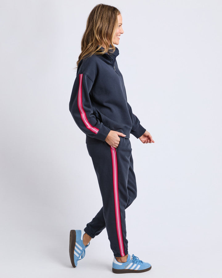 Behind The Trees- Person wearing a navy tracksuit with pink stripes on a white background-Elm - Lover- Track Pant- Navy