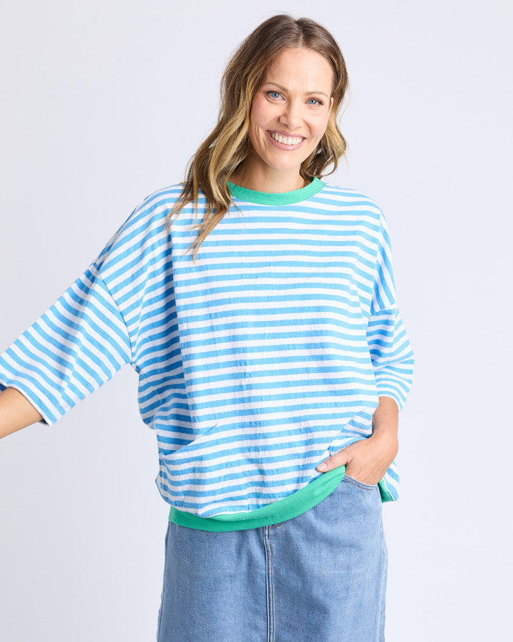 Behind The Trees - Woman wearing a blue and white striped sweater with a green trim on a light gray background - Elm - Mazie Stripe Ringer Sweat - Azure & White Stripe/Gumdrop Bands