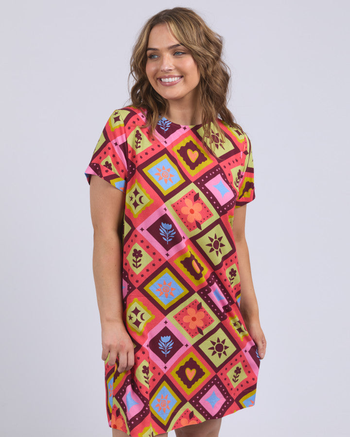 Behind The Trees - Woman wearing a colorful patterned dress against a plain background - Elm - Rhode Dress - Multicoloured Yardage Print