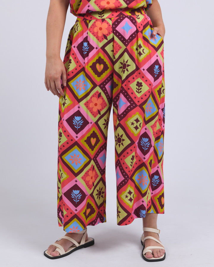 Behind The Trees - Person wearing colorful patterned pants on a white background - Elm - Rhode Pant - Rhode Geo Print