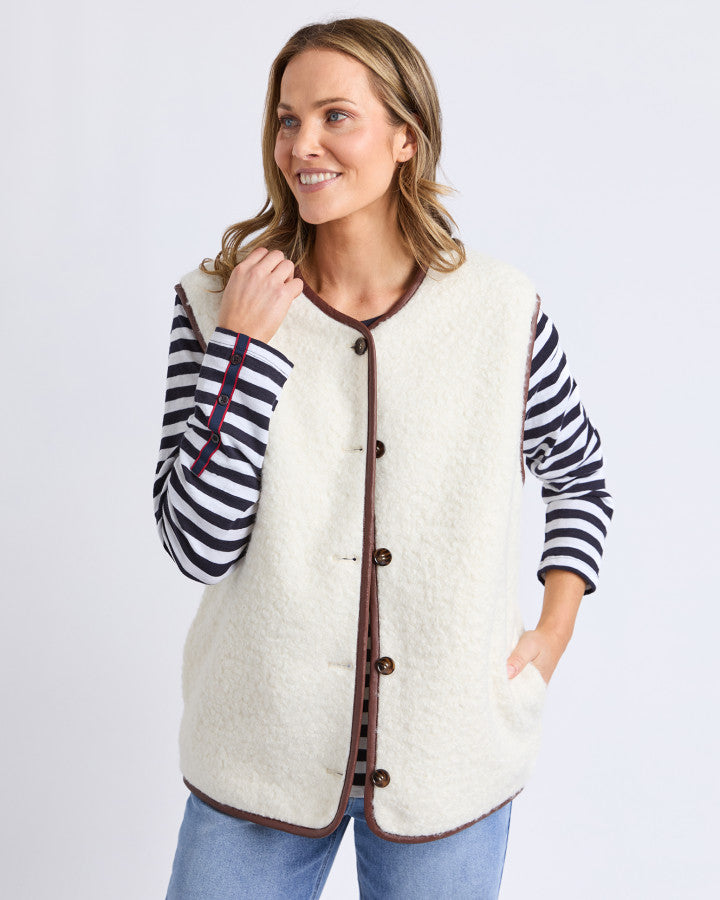 Behind The Trees - Woman wearing a cream-colored vest over a striped shirt on a white background - Elm - Sherling Vest - Marshmellow