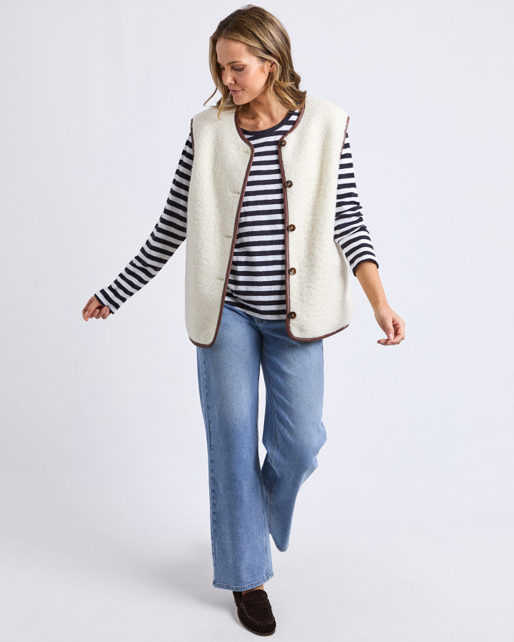 Behind The Trees - Woman wearing a cream-colored vest over a striped shirt on a white background - Elm - Sherling Vest - Marshmellow