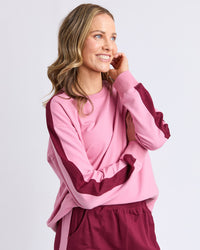 Behind The Trees - Woman wearing a pink and maroon outfit on a light gray background - Elm - Sloane Fleece Crew - Quartz Pink/ Plum Trim