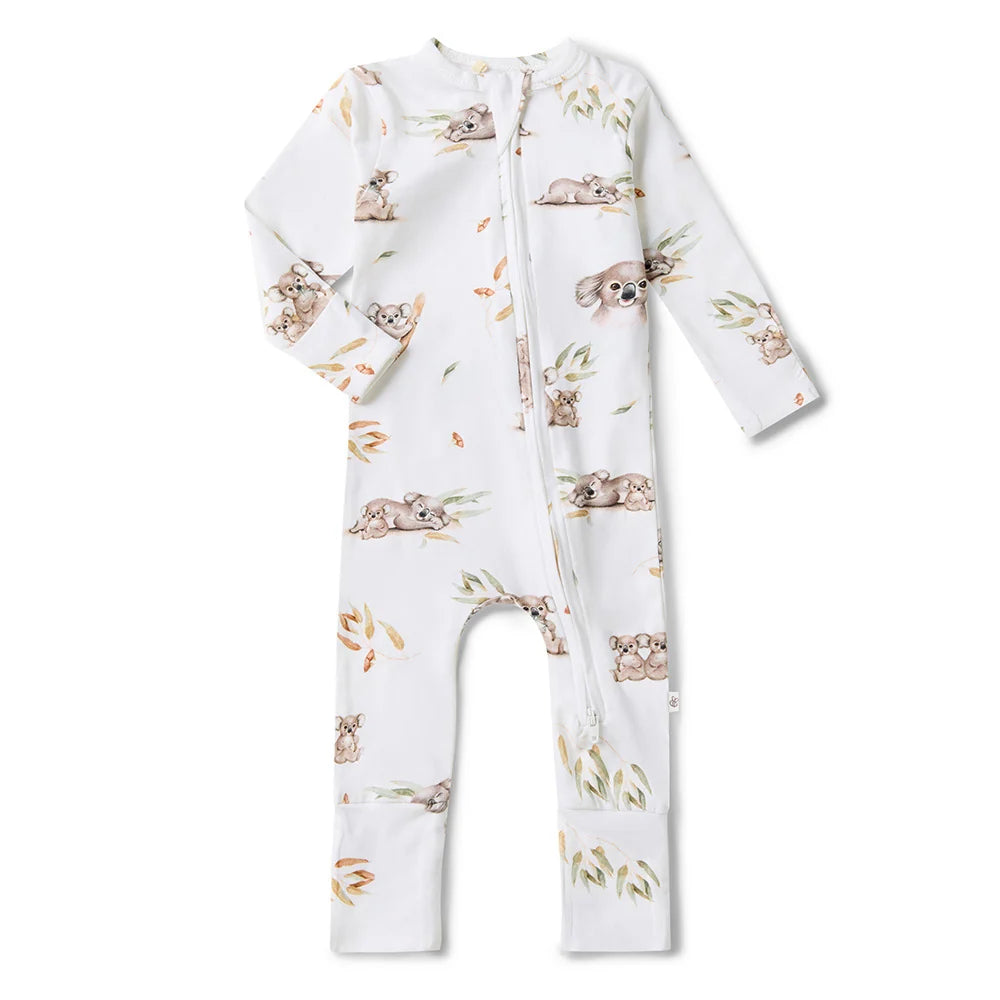 Behind The Trees - Baby wearing a white onesie with animal prints on a beige background - Snuggle Hunny - Organic Snugglesuit Convertible Romper - Koala