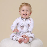 Behind The Trees - Baby wearing a white onesie with animal prints on a beige background - Snuggle Hunny - Organic Snugglesuit Convertible Romper - Koala
